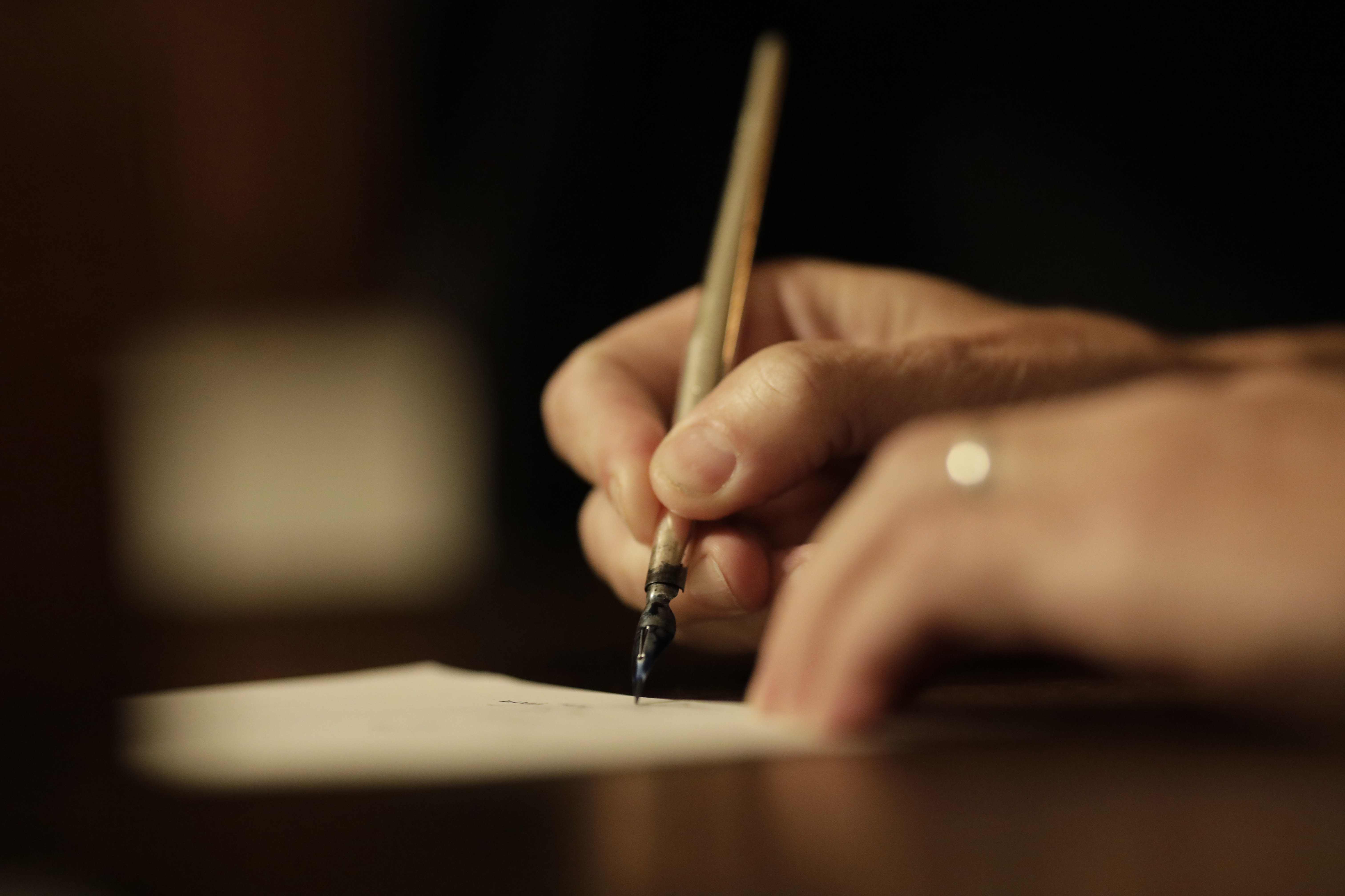 A silver pen signing a piece of paper