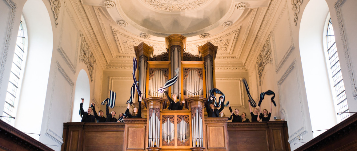 Image of students waving flags in the Chapel