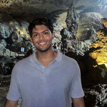Pasidu Perera wearing a light blue shirt, standing in a cave