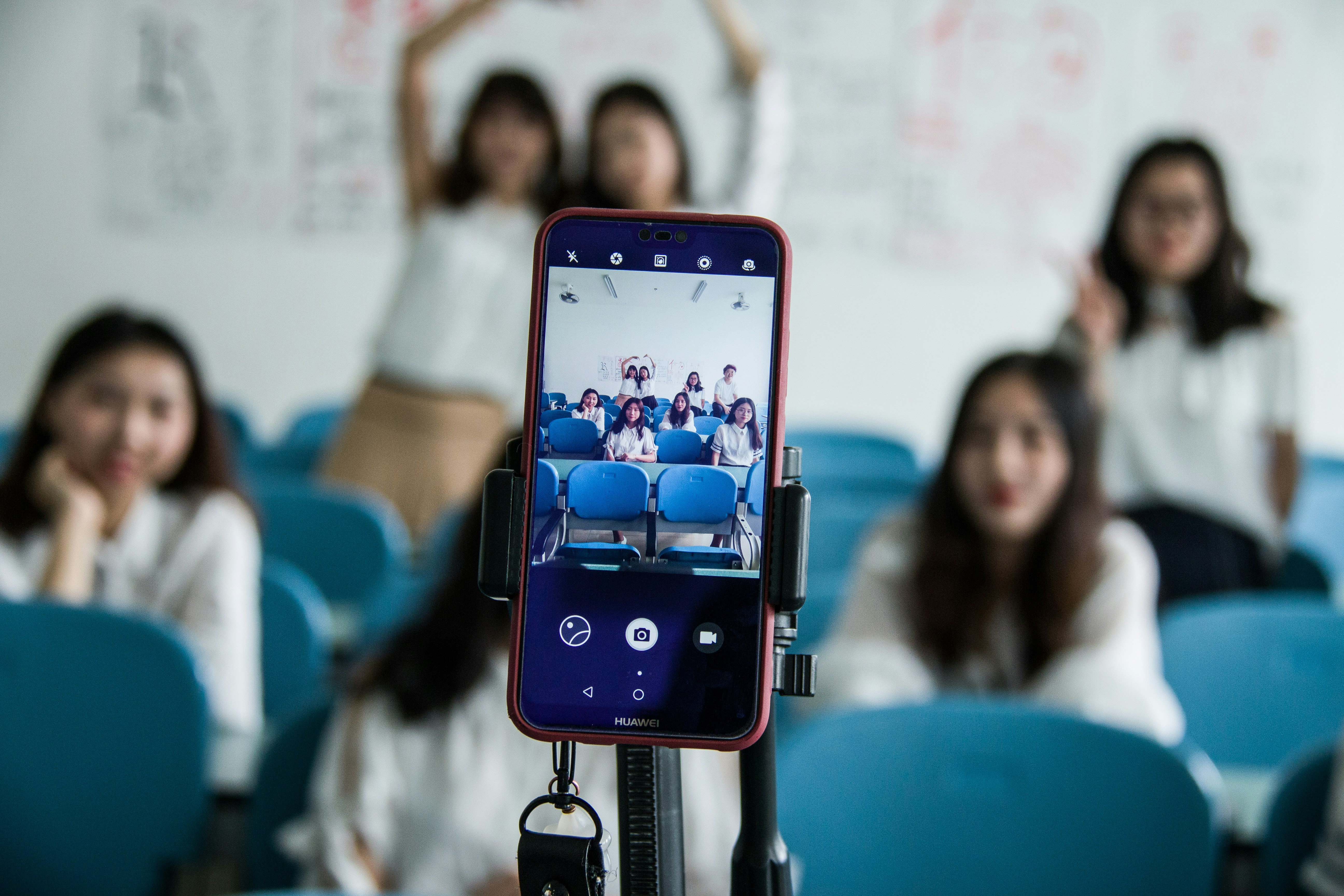 School children in a classroom using a phone