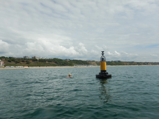 Swimming round a buoy off the Dorset coast