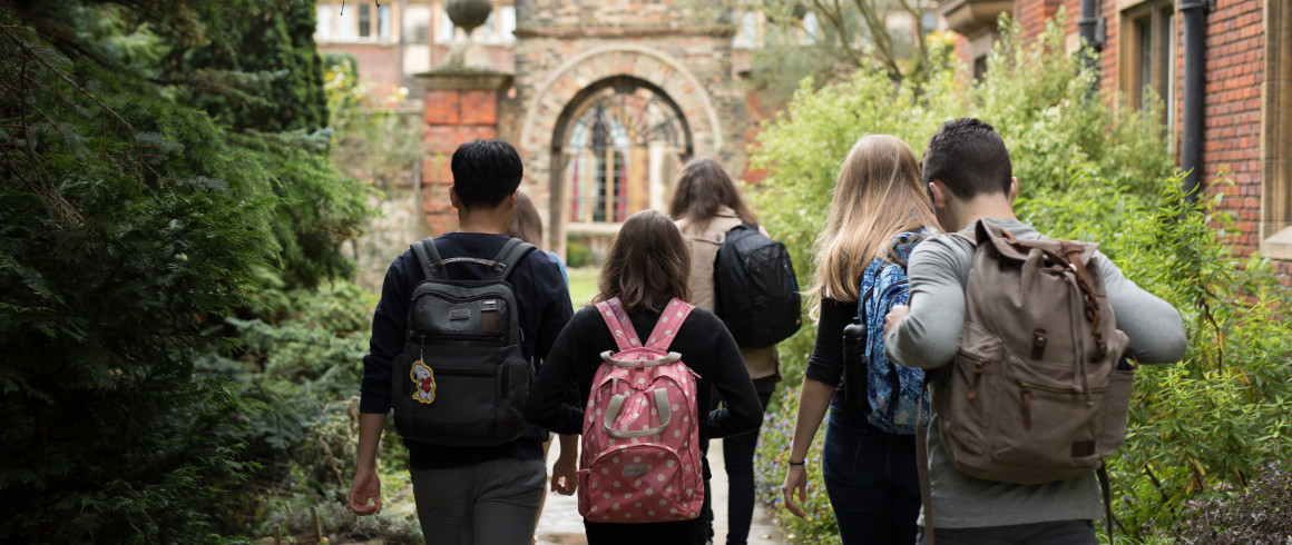 Image of students carrying bags exploring Pembroke's grounds.