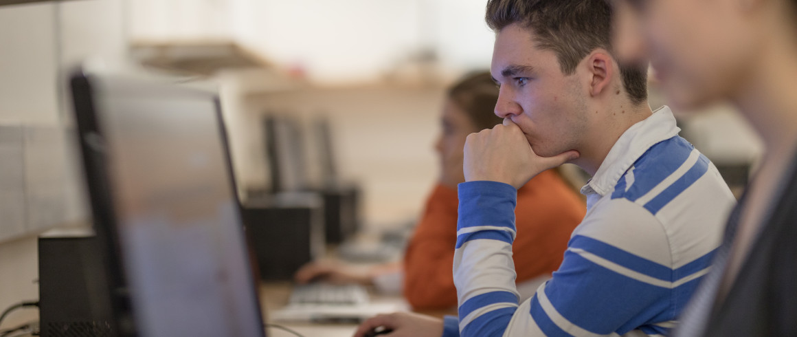 Image of student focusing on work on the computer