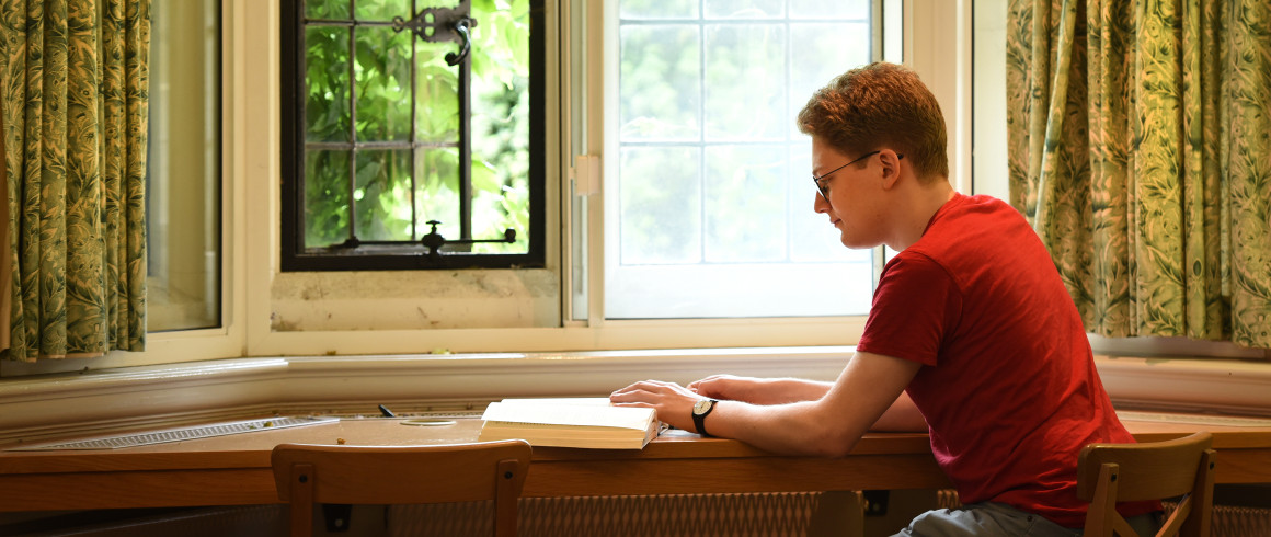Student studying at window