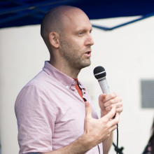 Mike Jackson holding and speaking into a microphone