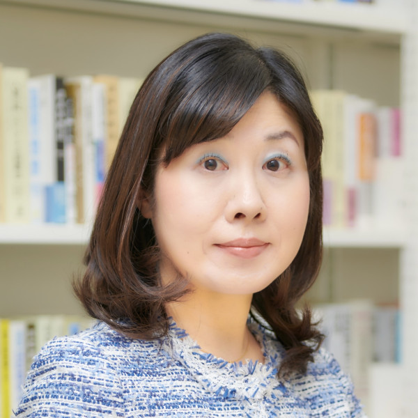 Professor Ando with bookshelves behind